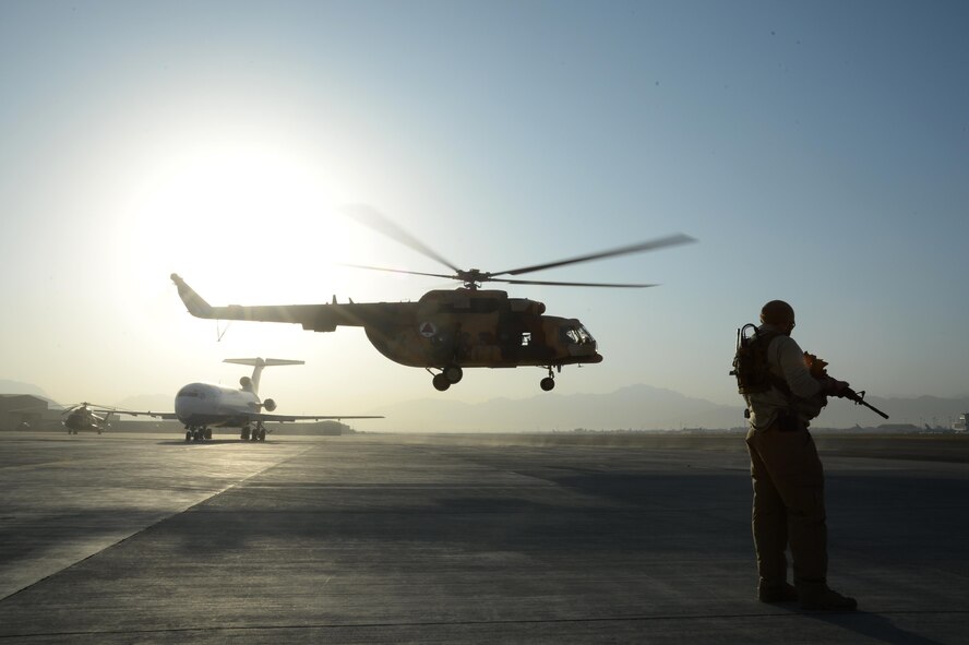 A Train, Advise, Assist Command-Air (TAAC-Air) security forces members stands guard as an Afghan Air Force Mi17 helicopter takes off at Hamid Karzai International Airport, Kabul, Afghanistan, Sept. 27, 2015. (U.S. Air Force photo by Staff Sgt. Sandra Welch/released)