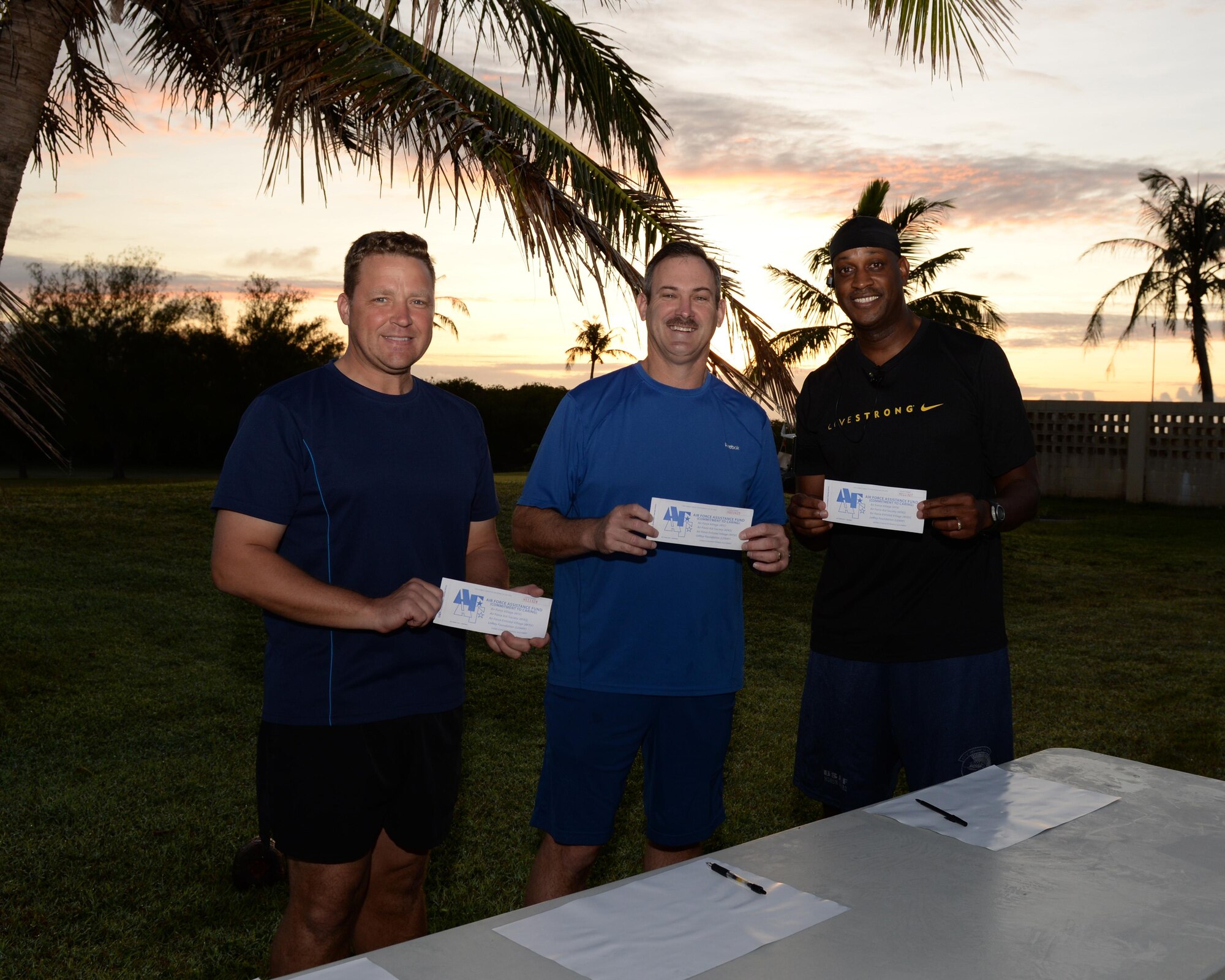 Col. Tyrell Chamberlain, 36th Wing vice commander, left, Brig. Gen. Andrew Toth, 36th Wing commander, and Chief Master Sgt. Michael McMillan, 36th Wing command chief pose for a photo after filling out Andersen’s first three donation slips to kick off the 2016 Air Force Assistance Fund March 21, 2016, at Andersen Air Force Base, Guam. The AFAF raises money annually for charitable organizations that provide support to Airmen and their families during emergencies, for educational needs, or to offer secure retirement homes for widows or widowers. (U.S. Air Force photo/Airman 1st Class Jacob Skovo)