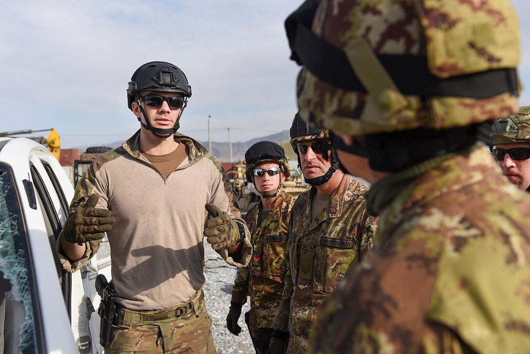 A U.S. airman, left, speaks with Italian soldiers during combined extrication training at Bagram Airfield, March 19, 2016. Air Force photo by Capt. Bryan Bouchard