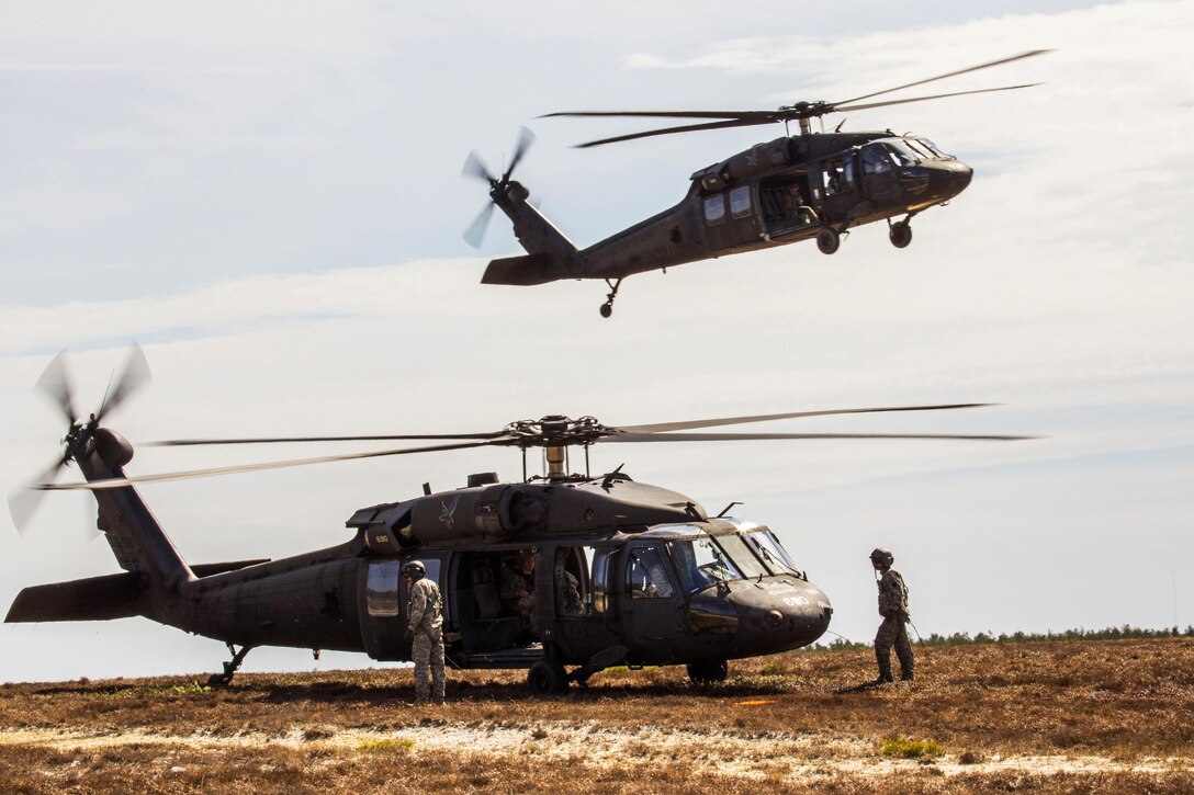 Two UH-60 Black Hawk helicopters take part in a joint training airborne operation at Coyle drop zone at Joint Base McGuire-Dix-Lakehurst, N.J., March 12, 2016. Airborne soldiers were conducting low-level static line jumps from the helicopters. New Jersey Air National Guard photo by Master Sgt. Mark C. Olsen