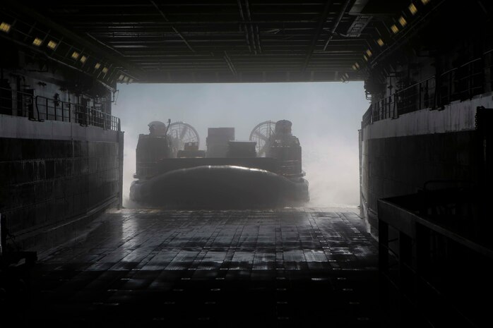 A U.S. Navy Landing Craft Air Cushion transporting Marines and vehicles with the 26th Marine Expeditionary Unit departs the amphibious transport dock ship USS Arlington (LPD 24) Feb. 4. Navy scientists and engineers are developing a modeling and simulation tool that will help determine if Marine Corps vehicles and equipment can be stowed on Navy vessels like the USS Arlington (LPD 24).   (U.S. Marine Corps photo by Cpl. Jeraco Jenkins)