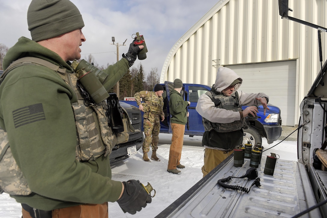 Airmen pack smoke grenades while preparing to conduct military working dog training at Joint Base Elmendorf-Richardson, Alaska, March 17, 2016. The airmen are assigned to the 673rd Security Forces Squadron. Air Force photo by Alejandro Pena