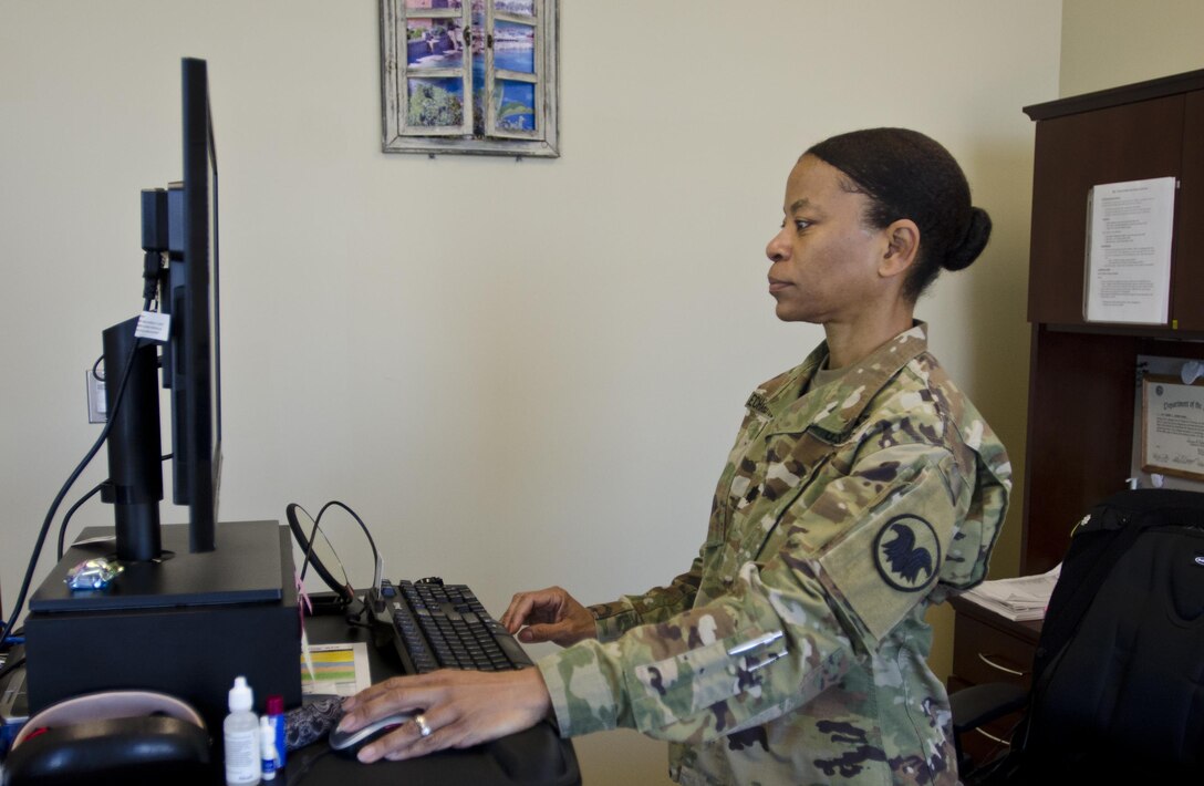 Lt. Col. Dianna Echard-Danis, detail inspector general with the U.S. Army Reserve Command, who credits much of her success in the military to inspirational women who have come before her, works on cases in her office at USARC headquarters, Fort Bragg, N.C., March 8, 2016. Danis spoke about her personal journey in the Army and how both men and women can use certain characteristics to join the inspector general directorate as she did. (U.S. Army Reserve photo by  Brian Godette, USARC Public Affairs)