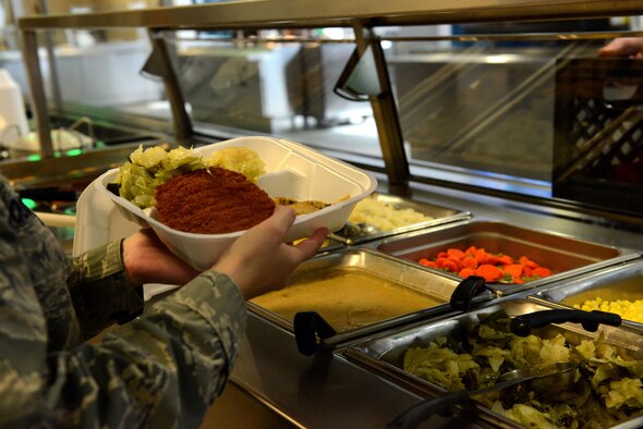 U.S. Air Force Staff Sgt. Lana Goodwin, 20th Force Support Squadron food services specialist, holds a plate of food at the Chief Master Sgt. Emerson E. Williams Dining Facility on Shaw Air Force Base, S.C., March 17, 2016. The dining facility serves approximately 800 meals a day and prepares breakfast, lunch, dinner, and midnight chow seven days a week. (U.S. Air Force photo by Airman 1st Class Destinee Dougherty)