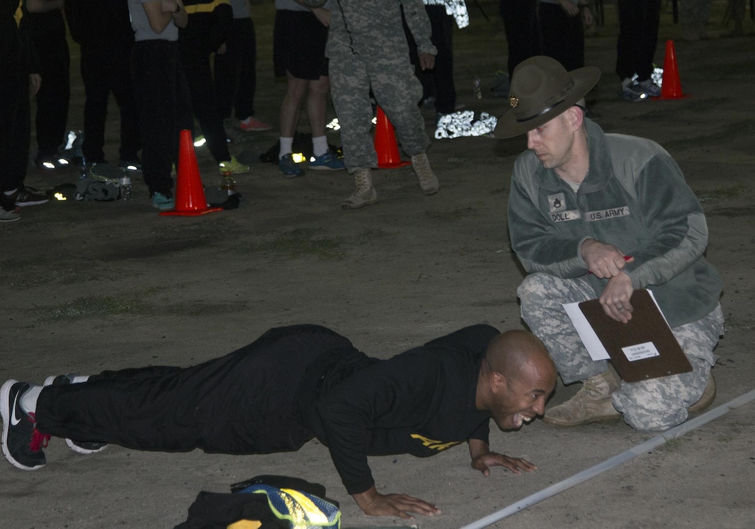 Army Reserve drill sergeant Staff Sgt. Kenneth A. Watson, 2nd Battalion, 389th Infantry Regiment, 98th Training Division (IET), grinds out his last push-up during the Army Physical Fitness Test (APFT) portion of the Drill Sergeant of the Year competition at Fort Jackson, S.C., March 22. The APFT was the first of 18 events, which the drill sergeants are tested on over a five-day period to determine which two will go on to compete at the TRADOC Drill Sergeant of the Year competition later this year at Fort Jackson, S.C. (U.S. Army photo by Sgt. Brandon Rizzo/released)