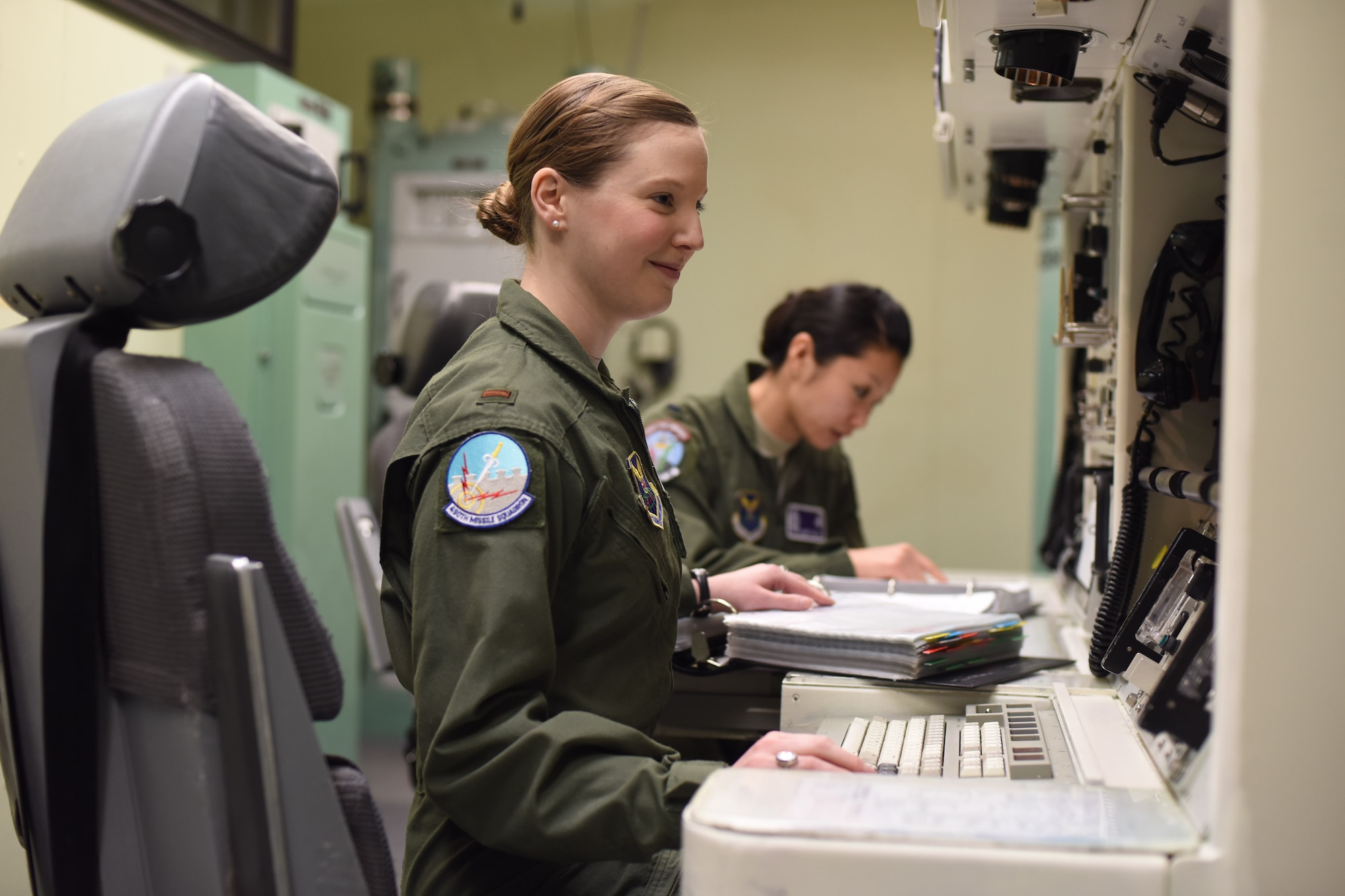 2nd Lt. Alexandra Rea, 490th Missile Squadron ICBM combat crew deputy director, left, and 1st Lt. Elizabeth Guidara, 12th Missile Squadron combat crew deputy director, perform training at the Malmstrom Air Force Base, Mont. Building 500 Missile Procedures Trainer March, 21, 2016. In honor of Women’s History Month, 90 female missileers based out of Minot Air Force Base, North Dakota, F.E. Warren AFB, Wyoming and Malmstrom AFB, Montana, will complete a 24-hour alert. In addition, B-52 aircrews from Minot and Barksdale AFB, Louisiana will participate by fielding all-female flight crews. (U.S. Air Force photo/Airman Collin Schmidt) 