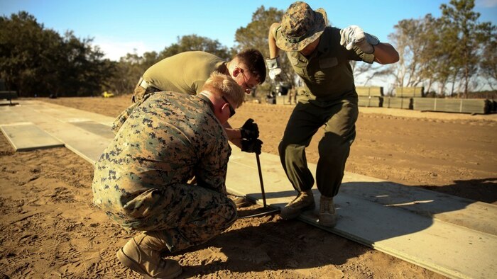 U.S. Marines with Marine Wing Support Squadron 272 construct a vertical take-off and landing pad during a Marine Corps Combat Readiness Evaluation at Marine Corps Auxiliary Landing Field Bogue, North Carolina, March 17, 2016. The MCCRE, which went from March 14-18, tested MWSS-272’s ability to build an AM-2 aluminum matting V/TOL pad ready to accept incoming aircraft. MWSS-272 is part of Marine Aircraft Group 26, 2nd Marine Aircraft Wing. 