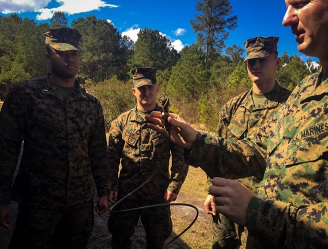 On March 2, 2016 Gunnery Sergeant Cheze, a Marine instructor with Combat Engineer Instruction Company, provides hands on learning about the non-electric initiation system to Combat Engineer Officers course 3-16 (CEO 3-16), pictured from left to right: Second Lieutenants Eric Johnson, Erik Henegar, and Eric Mederos; at Marine Corps Engineer School aboard Camp Lejeune, N.C.  This system used a non-electric blasting cap to detonate an explosive charge. 
