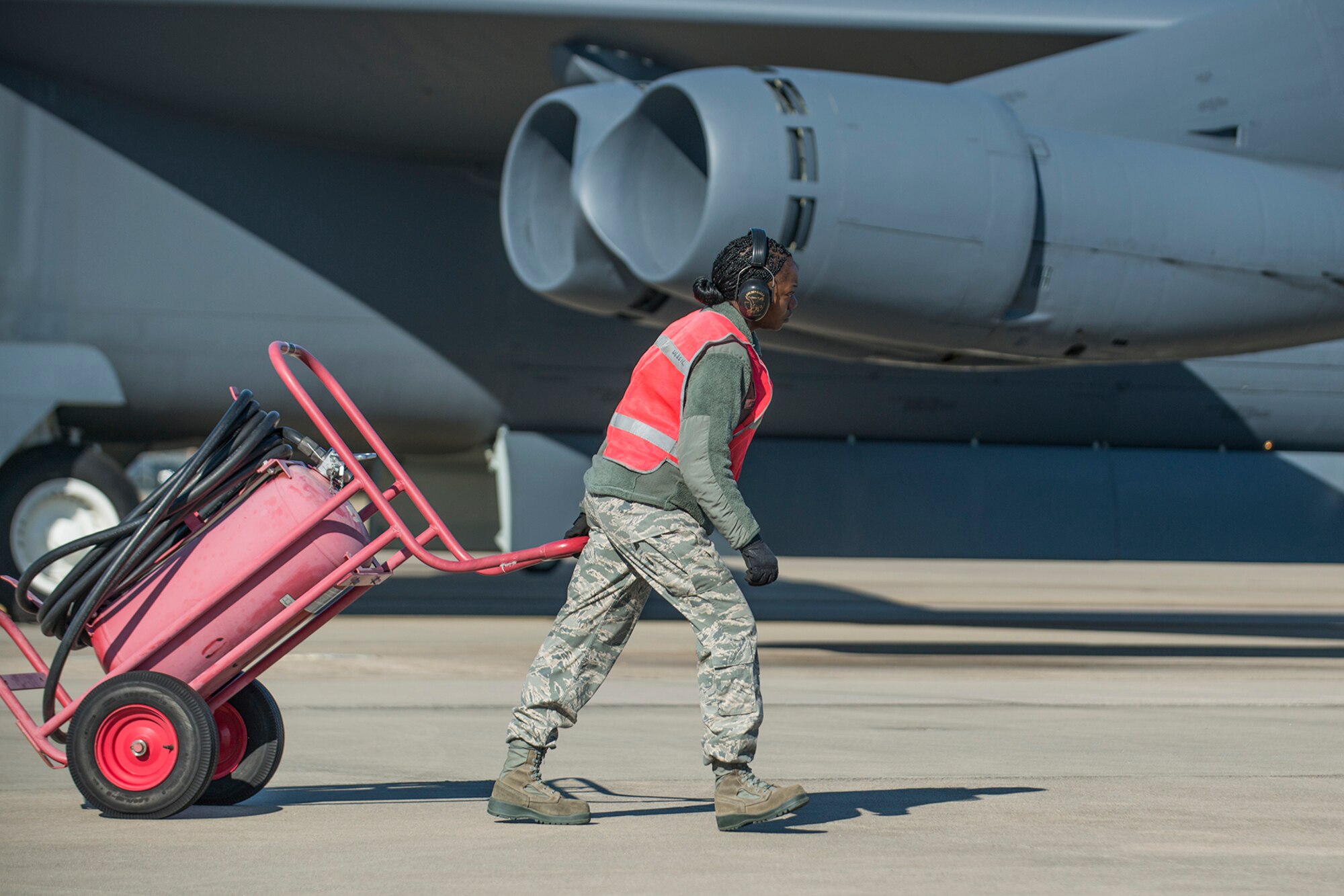U.S. Air Force Tech. Sgt. Holly Guerra, assigned to the 307th Aircraft Maintenance Squadron, moves a fire extinguisher out of the way of a B-52H Stratofortress prior to its taxi on Mar. 22, 2013, Barksdale Air Force Base, La. In recognition of Women’s History Month, the Air Force Reserve Command’s 307th Bomb Wing and Barksdale’s 2nd Bomb Wing launched two B-52H Stratofortress bombers flown by two all-female aircrews made up from members of the Air Force Reserve Command’s 93rd and 343rd Bomb Squadrons and the 2nd Bomb Wing’s 11th, 20th and 96th Bomb Squadrons. (U.S. Air Force photo by Master Sgt. Greg Steele/Released)
