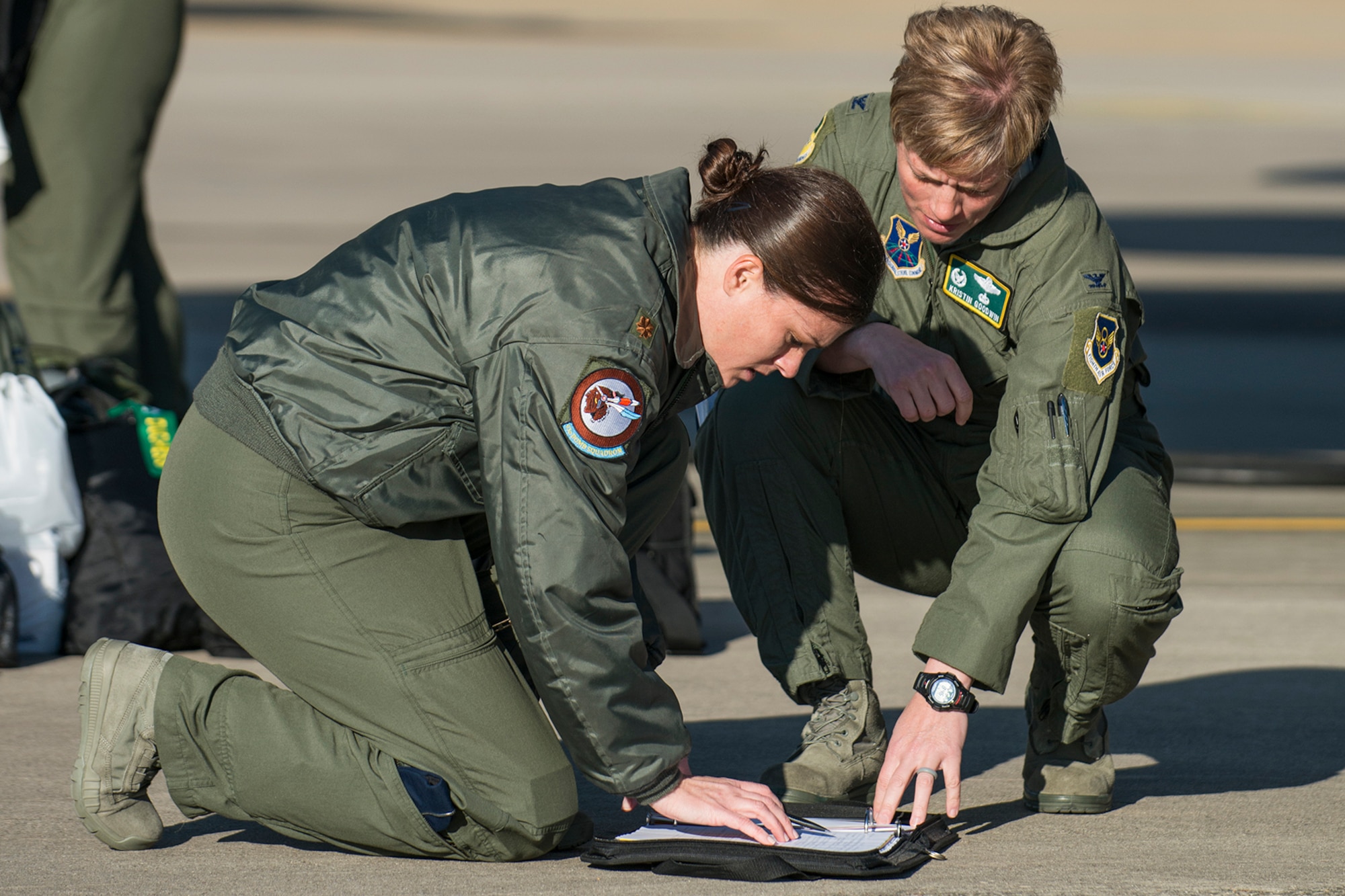 U.S. Air Force Maj. Heather Decker, of the 93rd Bomb Squadron, and Col. Kristin Goodwin, commander of the 2nd Bomb Wing, look over aircraft forms prior to a mission on Mar. 22, 2013, Barksdale Air Force Base, La. In recognition of Women’s History Month, the mission consisted of two B-52H Stratofortress bombers flown by two all-female aircrews made up from members of the Air Force Reserve Command’s 93rd and 343rd Bomb Squadrons and the 2nd Bomb Wing’s 11th, 20th and 96th Bomb Squadrons. (U.S. Air Force photo by Master Sgt. Greg Steele/Released)