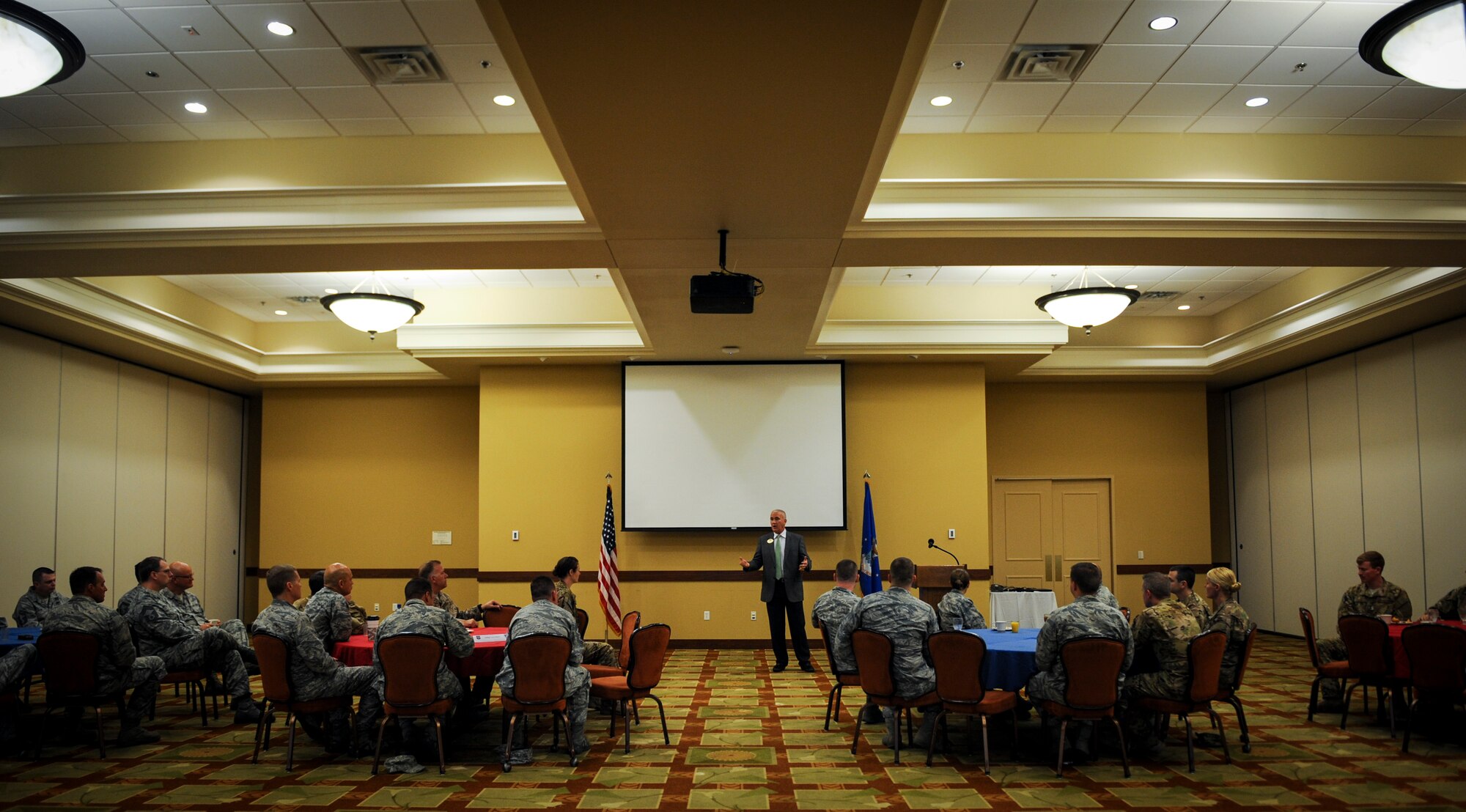 Retired Chief Master Sgt. Brooke McLean, president and CEO of the Air Force Enlisted Village, speaks to attendees to raise awareness about the AFEV during an Air Force Assistance Fund breakfast at Hurlburt Field, Fla., March 17, 2016. The AFAF raises money for charitable affiliates that provide support to Air Force families in need. The AFEV is one of four charitable affiliate organizations of AFAF whose core mission is to provide a safe, secure home for surviving spouses of retired enlisted U.S. Airmen. (U.S. Air Force photo by Senior Airman Meagan Schutter)