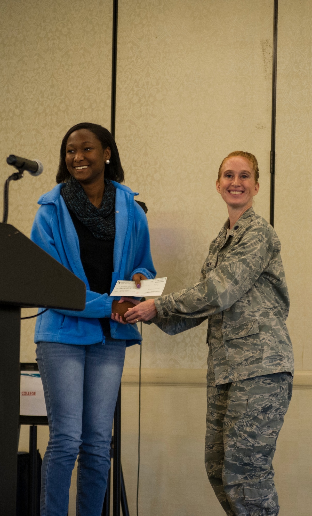 Lt. Col. Mary Jeffrey, 315th Operations Group executive officer, congratulates Shanyla Moultrie, of Cane Bay High School, for placing third place in the Women in Aviation Career Day essay contest. Over 130 middle and high school girls from 12 Lowcountry schools visited Joint Base Charleston March 22 to learn about jobs in aviation as part of the 315th Airlift Wing’s 9th annual Women in Aviation Career Day.	(U.S. Air Force photo by Senior Airman Jonathan Lane)