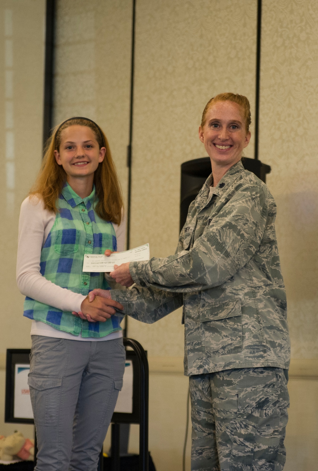 Lt. Col. Mary Jeffrey, 315th Operations Group executive officer, congratulates Jessica Turnbaugh, Hanahan High School, for winning 2nd place in the Women in Aviation Career Day essay contest.Over 130 middle and high school girls from 12 Lowcountry schools visited Joint Base Charleston March 22 to learn about jobs in aviation as part of the 315th Airlift Wing’s 9th annual Women in Aviation Career Day. (U.S. Air Force photo by Senior Airman Jonathan Lane)