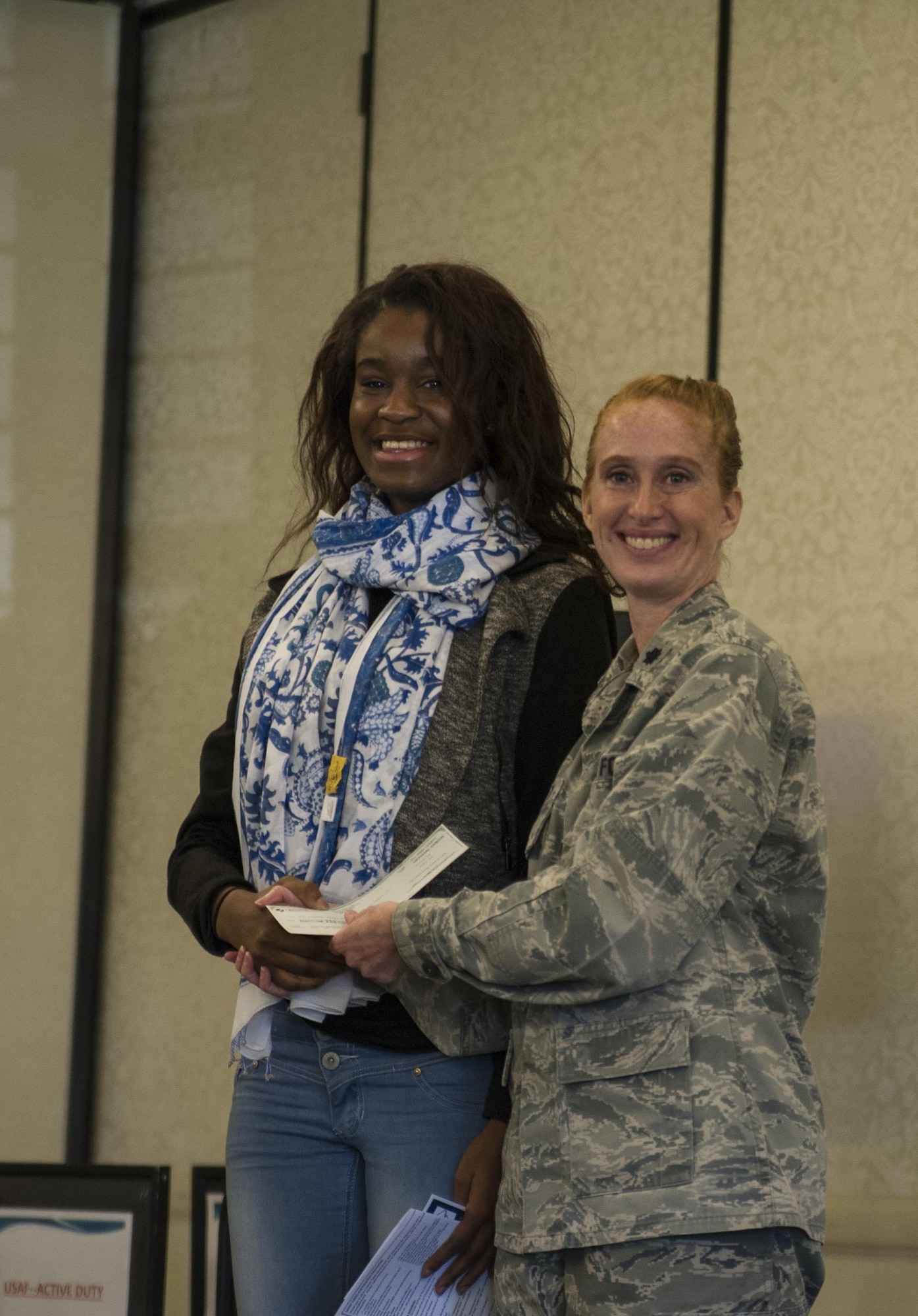 Lt. Col. Mary Jeffrey, 315th Operations Group executive officer, congratulates Ogugua Nwaezeigwe, Cane Bay High School,  for winning first place in the Women in Aviation Career Day essay contest.Over 130 middle and high school girls from 12 Lowcountry schools visited Joint Base Charleston March 22 to learn about jobs in aviation as part of the 315th Airlift Wing’s 9th annual Women in Aviation Career Day. (U.S. Air Force photo by Senior Airman Jonathan Lane)