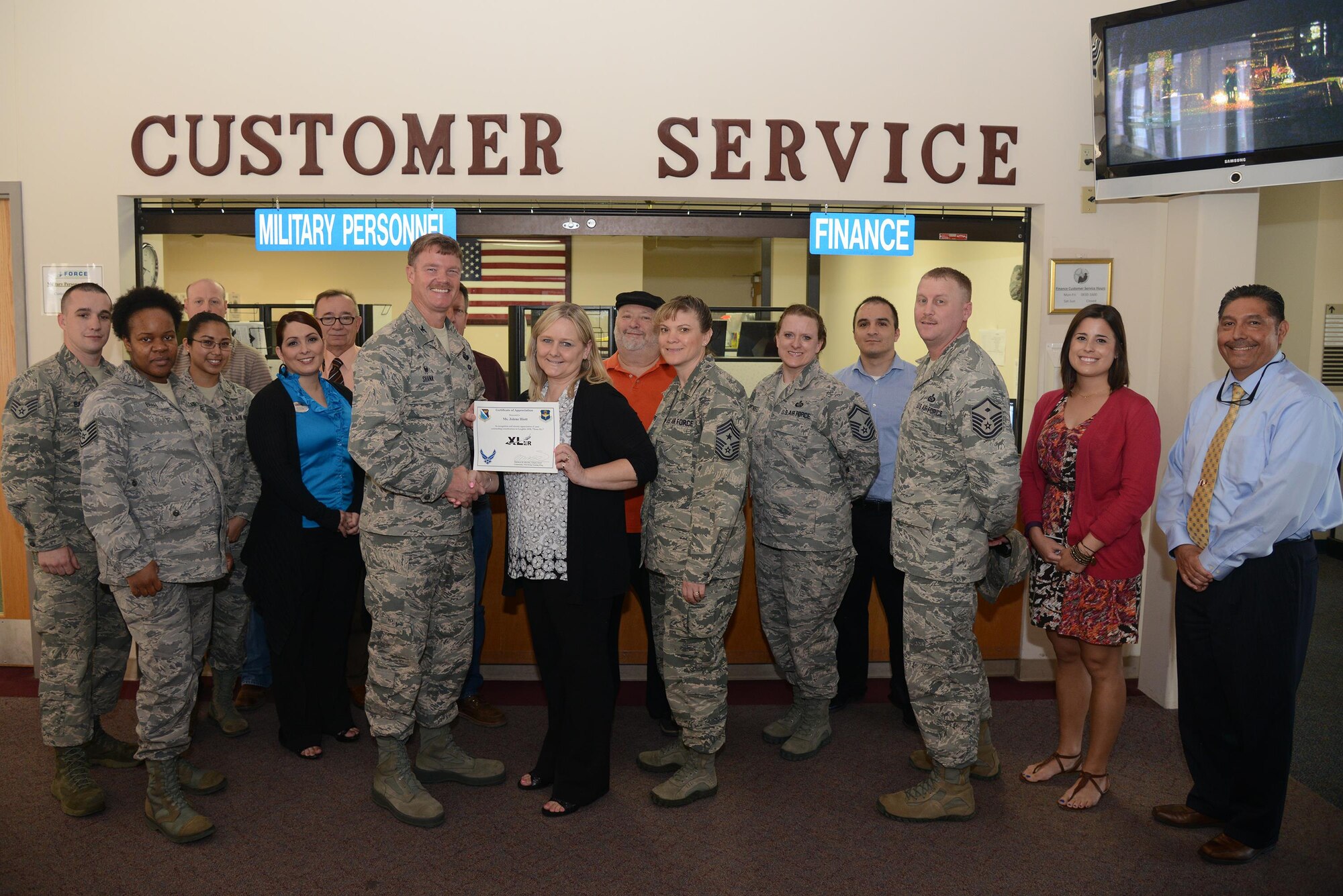 Jolene Hiott, center, 47th Force Support Squadron non-appropriated funds accounting office manager, accepts the “XLer of the Week” award from Col. Thomas Shank, left, 47th Flying Training Wing commander, and Chief Master Sgt. Teresa Clapper, right, 47th FTW command chief, here, March 15, 2016. The XLer is a weekly award chosen by wing leadership and is presented to those who consistently make outstanding contributions to their unit and Laughlin. (U.S. Air Force photo by Airman 1st Class Brandon May)

