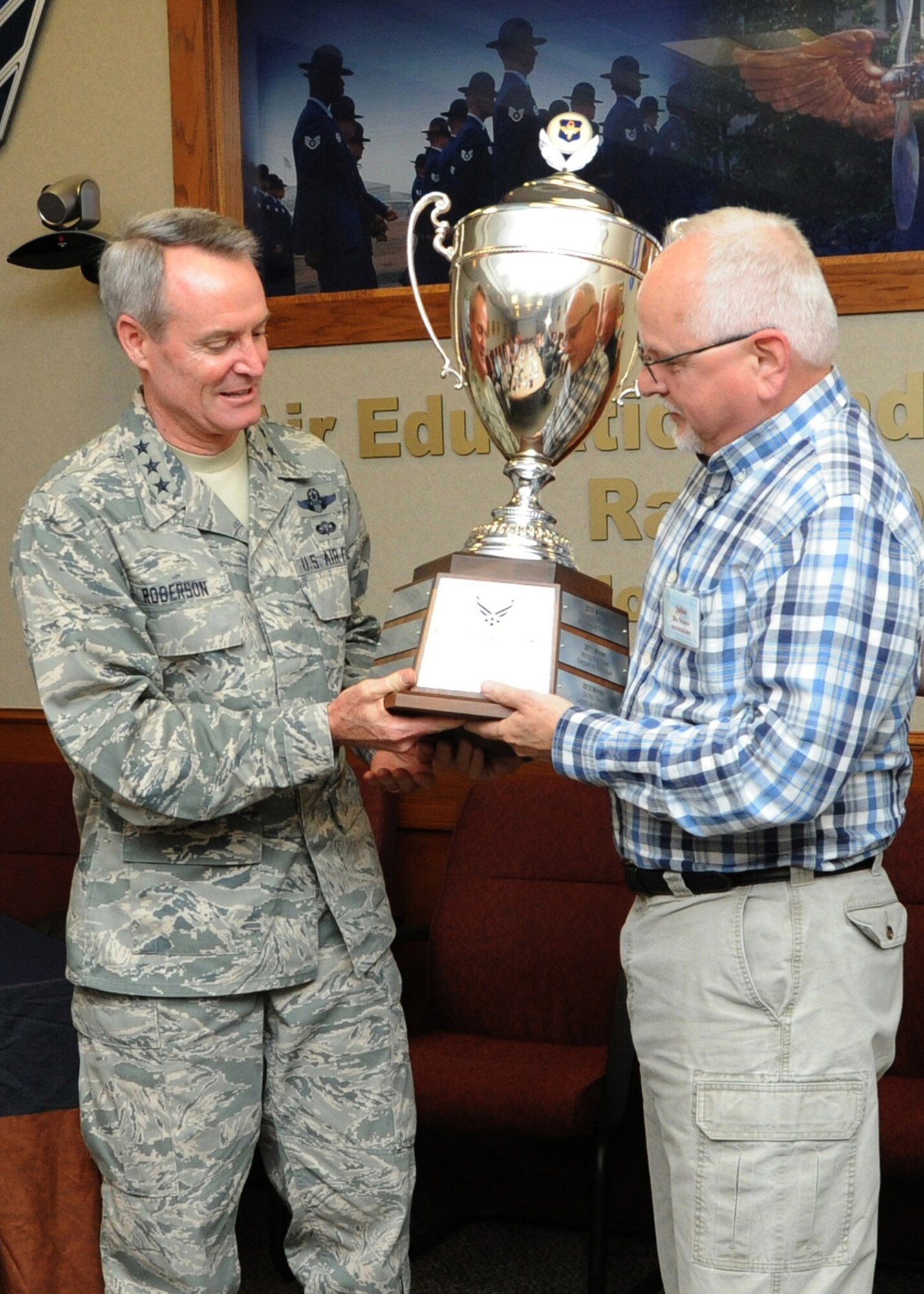 Lt. Gen. Darryl Roberson, commander of Air Education and Training Command, presents the 2015 Altus Trophy to John Veres, Chancellor of Auburn University in Montgomery, Alabama, March 23 at Joint Base San Antonio-Randolph, Texas. The Altus Trophy is given to the community judged to have shown the most outstanding support to an AETC base. Roberson announced Montgomery, Alabama, as the 2015 Altus Trophy winner during the AETC Commander's Civic Leader Group Spring Meeting here. (U.S. Air Force photo by Melissa Peterson)