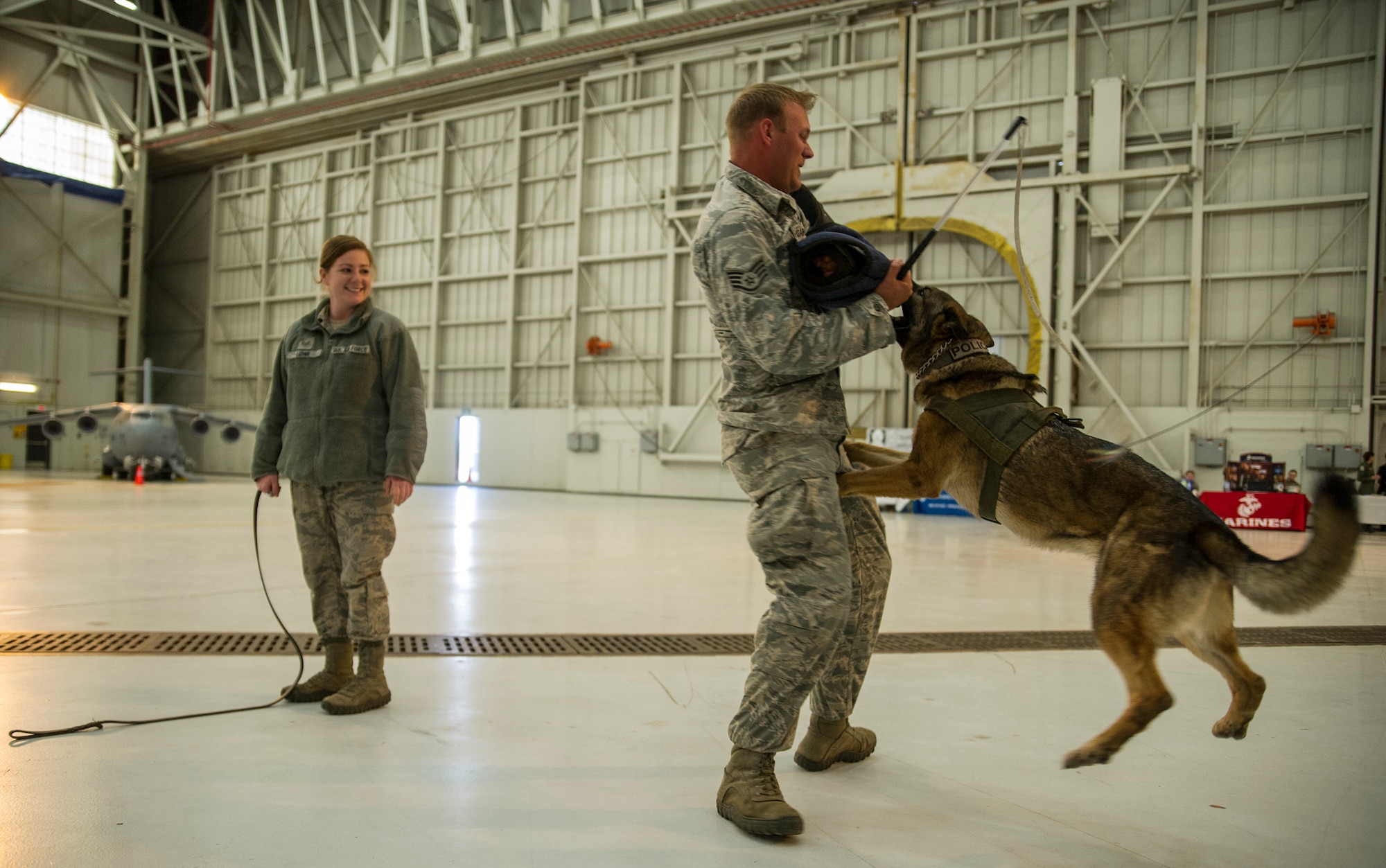 Members of the 628th Security Forces Squadron give a military working dog demonstration for local school girls. Over 130 middle and high school girls from 12 Lowcountry schools visited Joint Base Charleston March 22 to learn about jobs in aviation as part of the 315th Airlift Wing’s 9th annual Women in Aviation Career Day. (U.S. Air Force photo by Senior Airman Jonathan Lane)