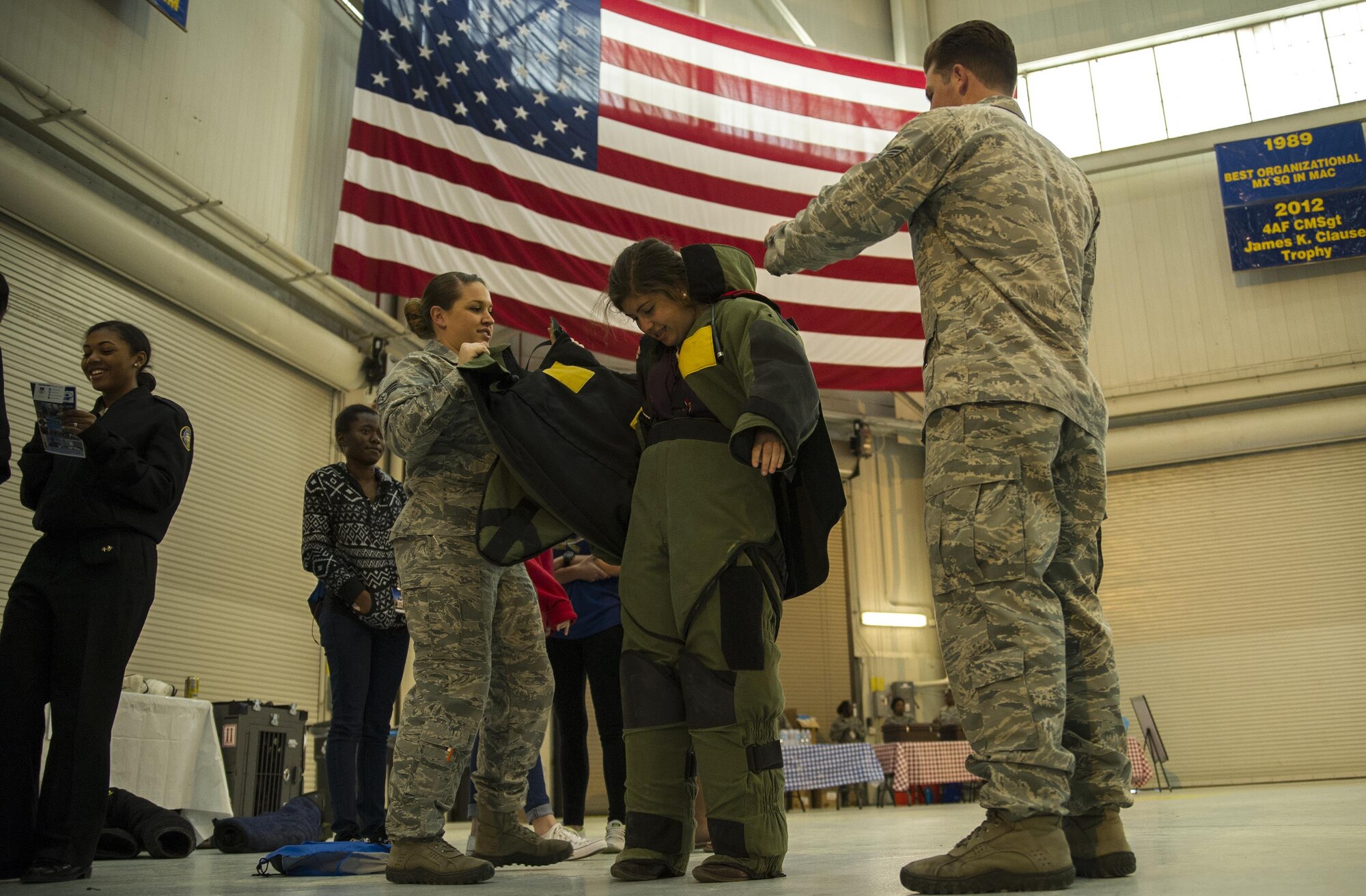 628th Explosive Ordinance technicians help a local school girl don a bomb suit at the Women in Aviation Career Day. Over 130 middle and high school girls from 12 Lowcountry schools visited Joint Base Charleston March 22 to learn about jobs in aviation as part of the 315th Airlift Wing’s 9th annual Women in Aviation Career Day. (U.S. Air Force photo by Senior Airman Jonathan Lane)