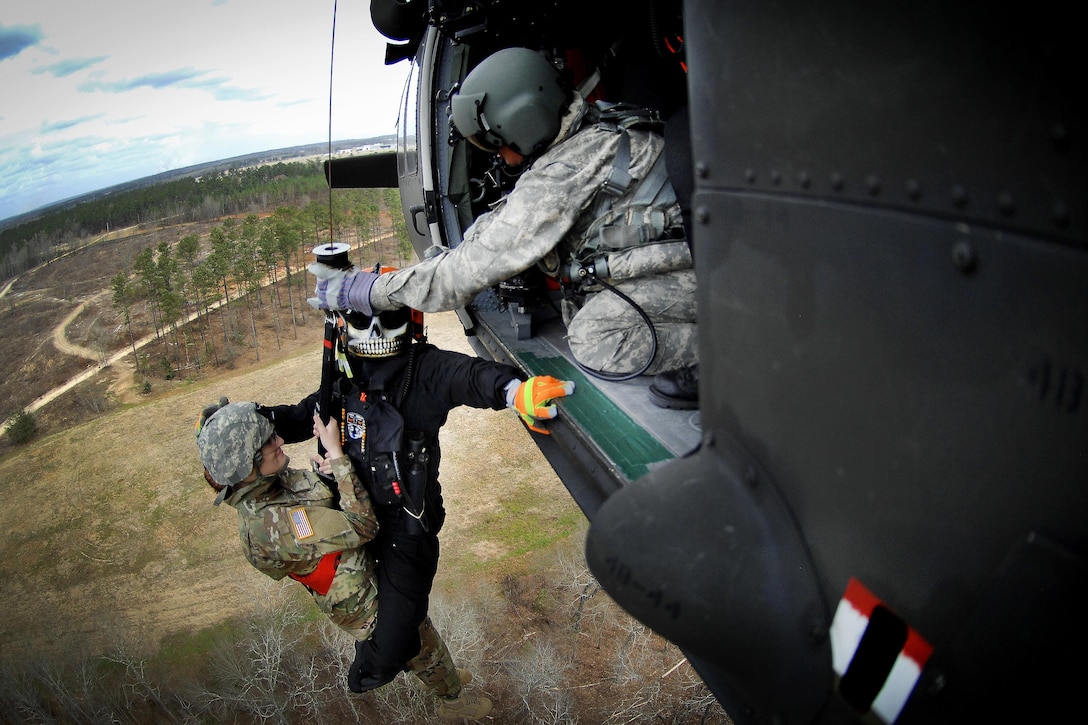 Soldiers and members of the South Carolina Helicopter Aquatic Rescue Team participate in a medevac training and certification mission in Eastover, S.C., March 9, 2016. The soldiers are assigned to the South Carolina Army National Guard’s 59th Aviation Troop Command. South Carolina Army National Guard photo by Staff Sgt. Roberto Di Giovine