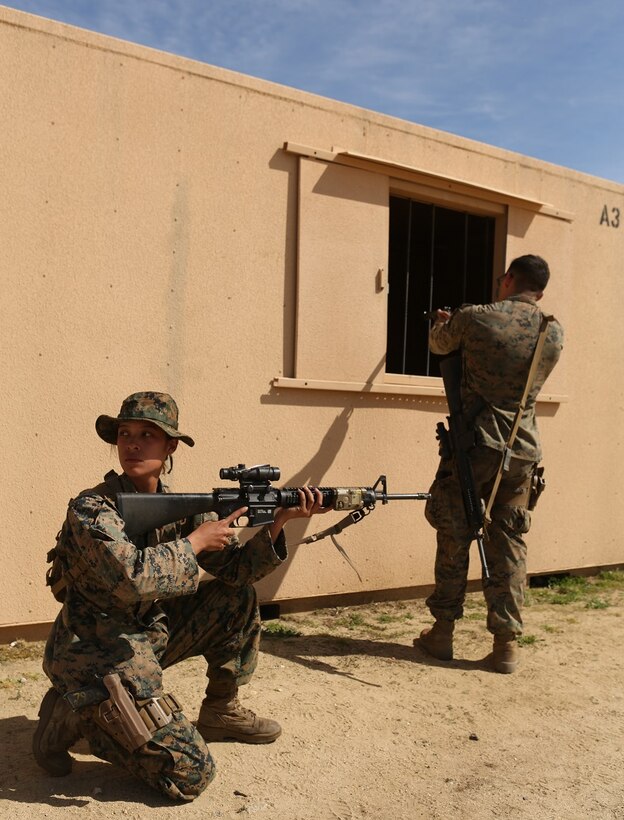 Cpl. Marissa Ezinga and Lance Cpl. Oscar Flores hold security during military operations on urban terrain training at Camp Pendleton March 3, 2016. Marines with 1st Law Enforcement Battalion performed a five-day offensive training evolution in an effort to better integrate military police officers with infantry units. Ezinga, a native of Vallejo, and Flores, a native of Redondo Beach, are military police officers with Company B, 1st LE Bn., I Marine Expeditionary Force. (U.S. Marine Corps photo by Lance Cpl. Justin E. Bowles/Released)