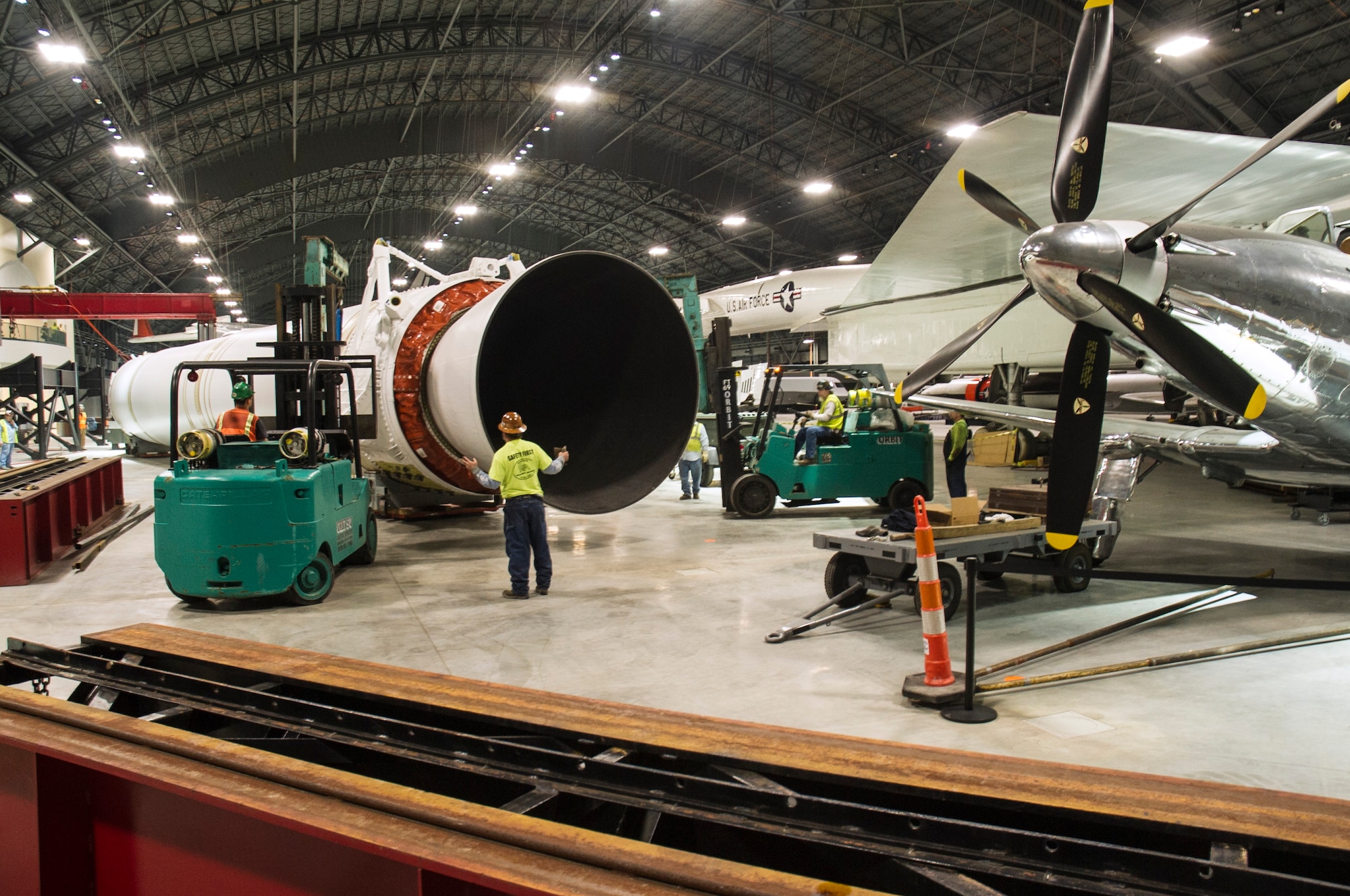 DAYTON, Ohio - Titan IVB stage one, and the solid rocket motor upgrades(SRMU's) were raised into their final position from 14-18 March, 2016. Orbit Industrial Contractors, Consolidated Machinery Movers, and museum restoration crews worked together using various lifts and a gantry crane system. The impressive Titan IVB, with roots going back to the early days of U.S. Air Force and civil space launch, is significant as the museum looks to share the story of USAF and USAF-enabled space operations in its Space Gallery. The Titan IVB will be on display in the new fourth building at the National Museum of the U.S. Air Force which opens to the public on June 8. (U.S. Air Force photo by Ken LaRock)