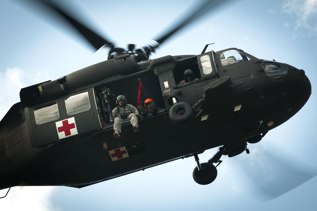 Soldiers and members of the South Carolina Helicopter Aquatic Rescue Team hover in a UH-60 Black Hawk helicopter while participating in a medevac training and certification mission in Eastover, S.C., March 9, 2016. South Carolina Army National Guard photo by Staff Sgt. Roberto Di Giovine
