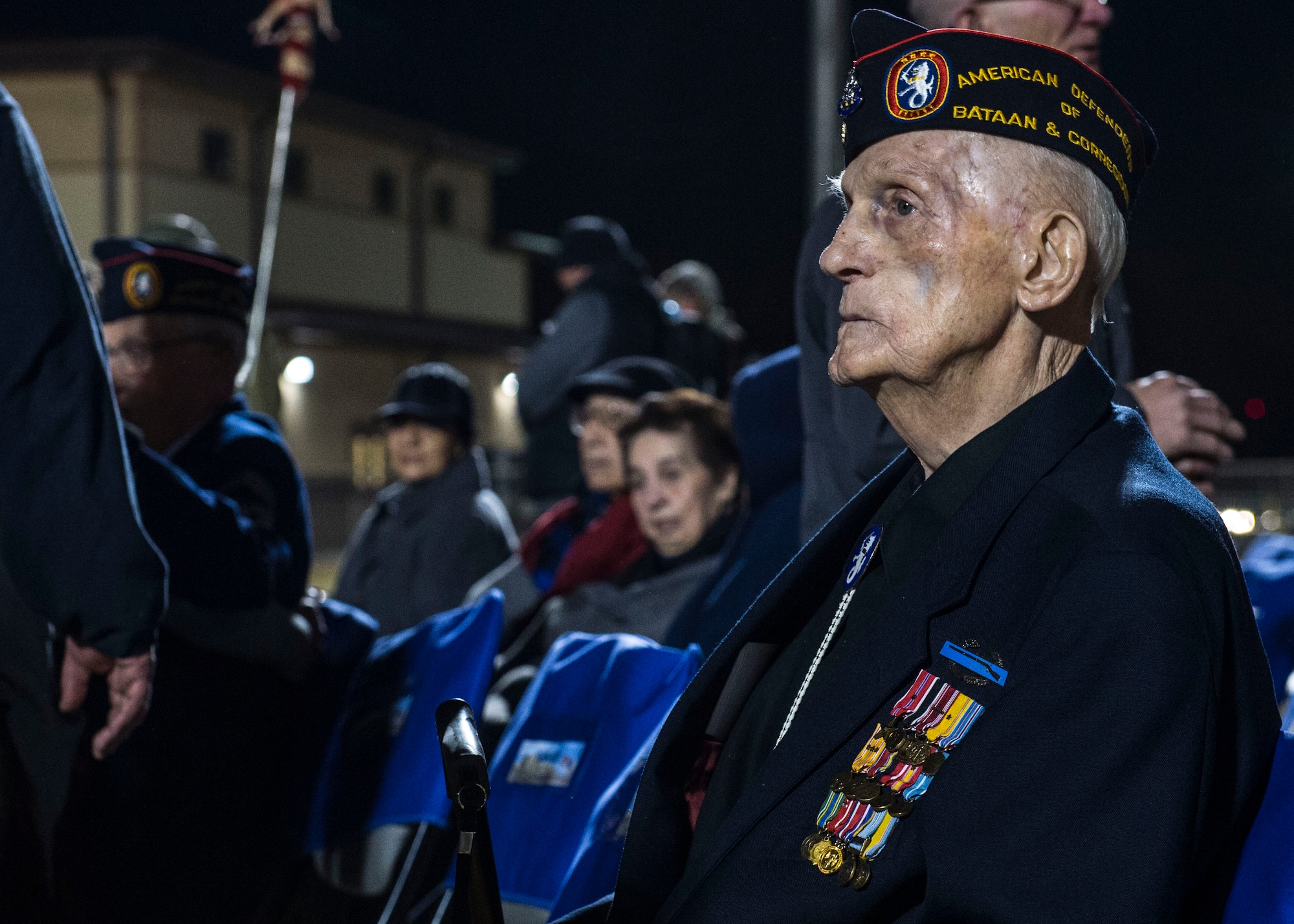 Retired U.S. Army Master Sgt. William Eldridge, greets guests and answers questions during the opening ceremony of the Bataan Memorial Death March at White Sands Missile Range N.M, March 20. Over 6,000 participants came to honor more than 76,000 Prisoners of War and Missing in Action from Bataan and Corregidor during World War II. The 26.2-mile course starts on WSMR, enters hilly terrain and finishes through sandy desert trails, with elevation ranging from 4,100 to 5,300 feet. (U.S. Air Force photo by Senior Airman Chase Cannon)