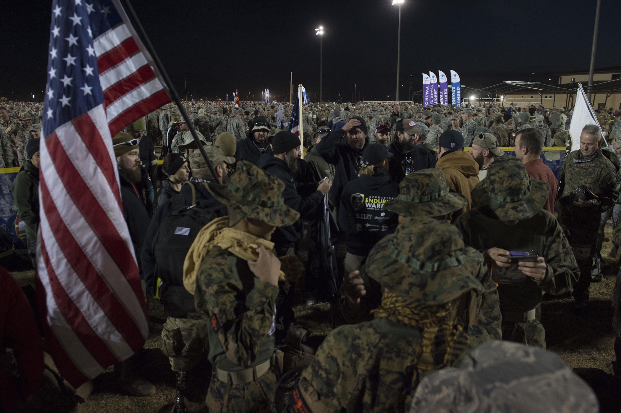 Participants in the Bataan Memorial Death March gather before the opening ceremony at White Sands Missile Range N.M., March 20. Over 6,000 participants came to honor more than 76,000 Prisoners of War and Missing in Action from Bataan and Corregidor during World War II. The 26.2-mile course starts on WSMR, enters hilly terrain and finishes through sandy desert trails, with elevation ranging from 4,100 to 5,300 feet. (U.S. Air Force photo by Senior Airman Chase Cannon)