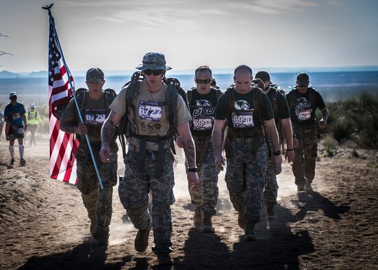 A team of participants in 2016 Bataan Memorial Death March make their way through the course at White Sands Missile Range N.M., March 20. Over 6,000 participants came to honor more than 76,000 Prisoners of War and Missing in Action from Bataan and Corregidor during World War II. The 26.2-mile course starts on WSMR, enters hilly terrain and finishes through sandy desert trails, with elevation ranging from 4,100 to 5,300 feet. (U.S. Air Force photo by Senior Airman Chase Cannon)
