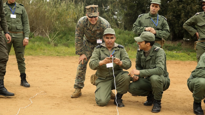 U.S. Marine Staff Sgt. Phil Mayer, an explosive ordnance disposal technician with Special-Purpose Marine Air-Ground Task Force Crisis Response-Africa, observes as a Moroccan soldier simulates firing an electric blasting machine during a training exercise in Kenitra, Morocco, March 15, 2016. Students from across the Moroccan military branches are working together with U.S. Marine and Utah Air National Guard explosive ordnance disposal technicians and Utah National Guard engineers to build up Morocco’s demining capabilities. The training is part of the U.S. Humanitarian Mine Action Program which has been assisting partner nations in developing their mine action capacity since 1988.