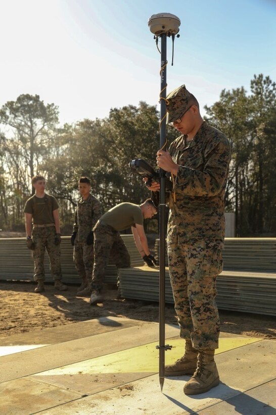 A U.S. Marine with Marine Wing Support Squadron 272 measures elevation levels AM-2 aluminum matting during a Marine Corps Combat Readiness Evaluation at Marine Corps Auxiliary Landing Field Bogue, N.C., March 17, 2016. The MCCRE, which went from March 14-18, tested MWSS-272’s ability to build an AM-2 aluminum matting V/TOL pad ready to accept incoming aircraft. MWSS-272 is part of Marine Aircraft Group 26, 2nd Marine Aircraft Wing. (U.S. Marine Corps photo by Cpl. Kaitlyn V. Klein/Released)