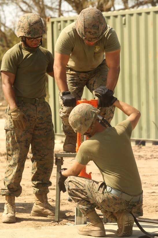 U.S. Marines with Marine Wing Support Squadron 272 drive stakes into the ground around the perimeter of a vertical take-off and landing pad during a Marine Corps Combat Readiness Evaluation at Marine Corps Auxiliary Landing Field Bogue, N.C., March 17, 2016. The MCCRE, which went from March 14-18, tested MWSS-272’s ability to build an AM-2 aluminum matting V/TOL pad ready to accept incoming aircraft. MWSS-272 is part of Marine Aircraft Group 26, 2nd Marine Aircraft Wing. (U.S. Marine Corps photo by Cpl. Kaitlyn V. Klein/Released)