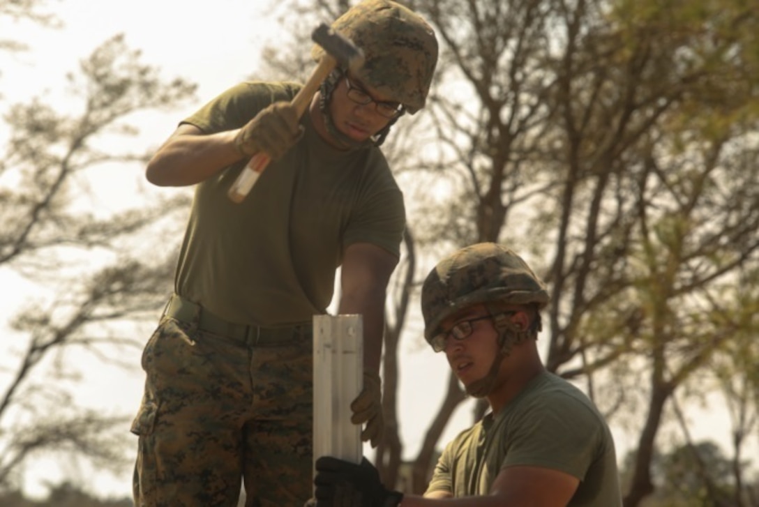 U.S. Marines with Marine Wing Support Squadron 272 drive stakes into the ground around the perimeter of a vertical take-off and landing pad during a Marine Corps Combat Readiness Evaluation at Marine Corps Auxiliary Landing Field Bogue, N.C., March 17, 2016. The MCCRE, which went from March 14-18, tested MWSS-272’s ability to build an AM-2 aluminum matting V/TOL pad ready to accept incoming aircraft. MWSS-272 is part of Marine Aircraft Group 26, 2nd Marine Aircraft Wing. (U.S. Marine Corps photo by Cpl. Kaitlyn V. Klein/Released)