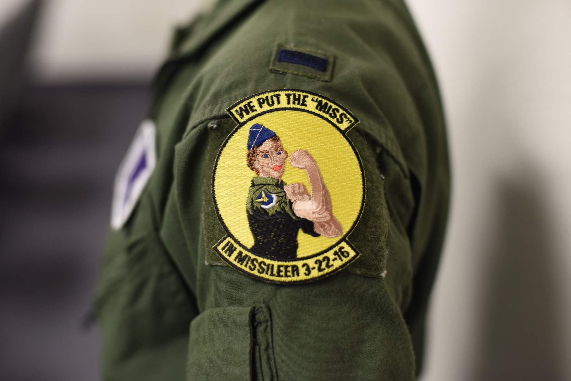 A missileer from Malmstrom Air Force Base, Mont., presents her patch after a training session at the missile procedures trainer March 21, 2016. According to the U.S. Census Bureau, women make up almost 51 percent of the nation’s population. Women currently make up 19 percent of the Air Force, the highest of any service. (U.S. Air Force photo/Airman Collin Schmidt)