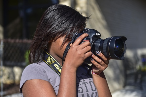 Zayiah Craig, 11, takes photos of nature at the Hurlburt Field Youth Center, March 14, 2016. Craig’s passion for photography began two years ago when she took photos during a family vacation. (U.S. Air Force photo by Senior Airman Jeff Parkinson)
