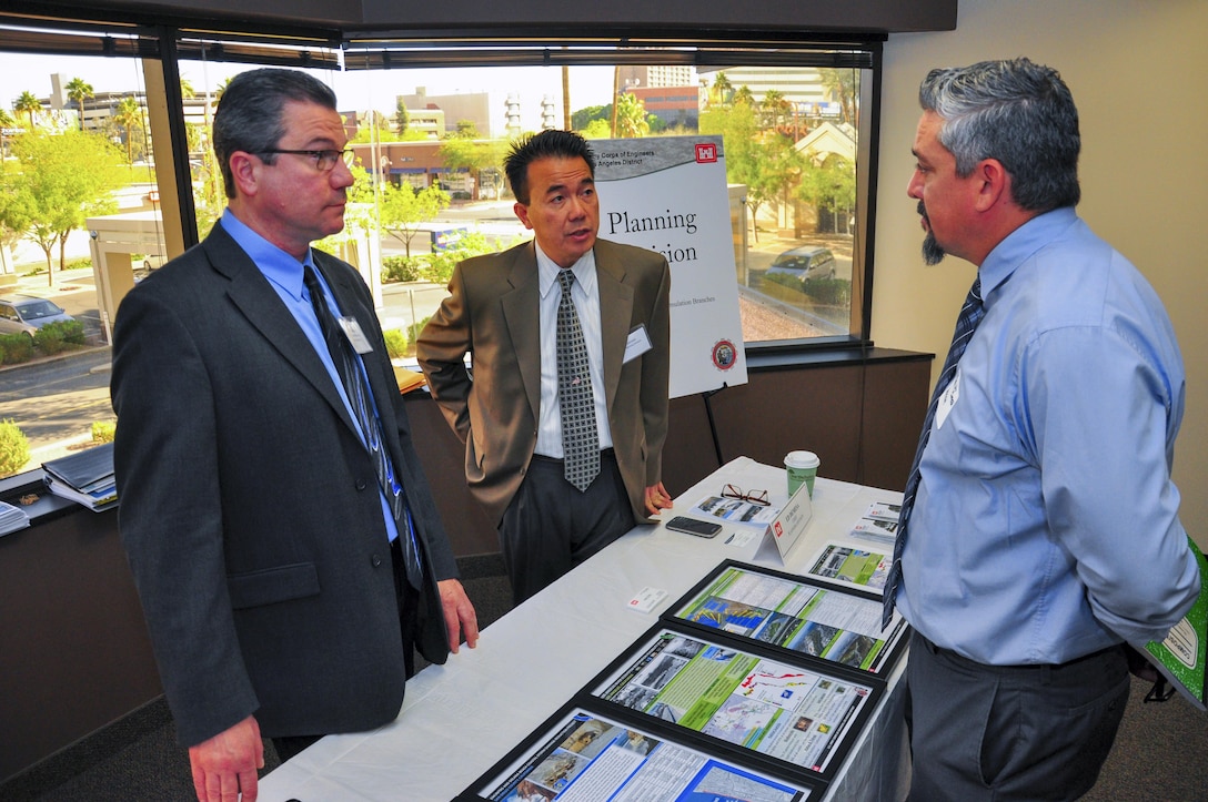 The Los Angeles District’s Kim Gavigan (left), chief of the water resources planning section and Ed Demesa, chief of the planning division, speak with a contractor at the Arizona-Nevada Area Office's Business Opportunities Open House March 17. The event featured morning and afternoon sessions with two training opportunities; successful proposal preparation, and job site safety.  