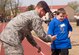 A Special Olympian is congratulated by a member of the 71st Security Forces Squadron as he completes a run during the 46th Annual Cherokee Strip Area 6 Special Olympics at Vance Air Force Base, Oklahoma, March 23. More than 200 athletes competed in the games and the winners will compete in the Special Olympics Oklahoma games this summer. (U.S. Air Force photo/ David Poe)