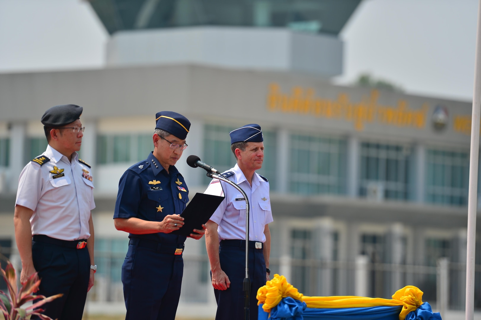 Republic of Singapore Air Force Brig. Gen. Hoo Cher Mou, chief of air force, Royal Thai Air Force Air Chief Marshal Treetod Sonjance, RTAF commander-in-chief, and U.S. Air Force Maj. Gen. Micheal Compton, Air National Guard assistant to the commander at Pacific Air Forces from Joint Base Pearl Harbor-Hickam, Hawaii, co-officiate the closing ceremony of Exercise Cope Tiger 16 on Korat Royal Thai Air Force Base, Thailand, March 18, 2016. Cope Tiger, which is in its 22nd year, is an annual multilateral aerial exercise supporting regional peace and security by improving readiness and multi-national interoperability between the Republic of Singapore Air Force, Royal Thai Air Force, and U.S. Air Force. (U.S. Air Force Photo by Tech Sgt. Aaron Oelrich/Released)