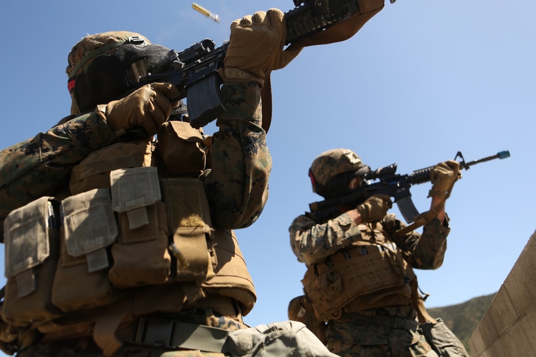 Lance Cpl. Brandon D. Peace and Lance Cpl. Roger T. Freckleton return fire atop the roof of a simulated patrol base during a three-week urban operations course led by 1st Marine Division Schools, Urban Leaders Course at Camp Pendleton March 8, 2016. Peace, a native of San Antonio, is a military police officer with Company B, 1st Law Enforcement Battalion, I Marine Expeditionary Force Headquarters Group. Freckleton, a native of Newport, New Hampshire, is a rifleman with Company D, 1st Light Armored Reconnaissance, 1st Marine Division. (U.S. Marine Corps photo by Lance Cpl. Justin E. Bowles/ Released)