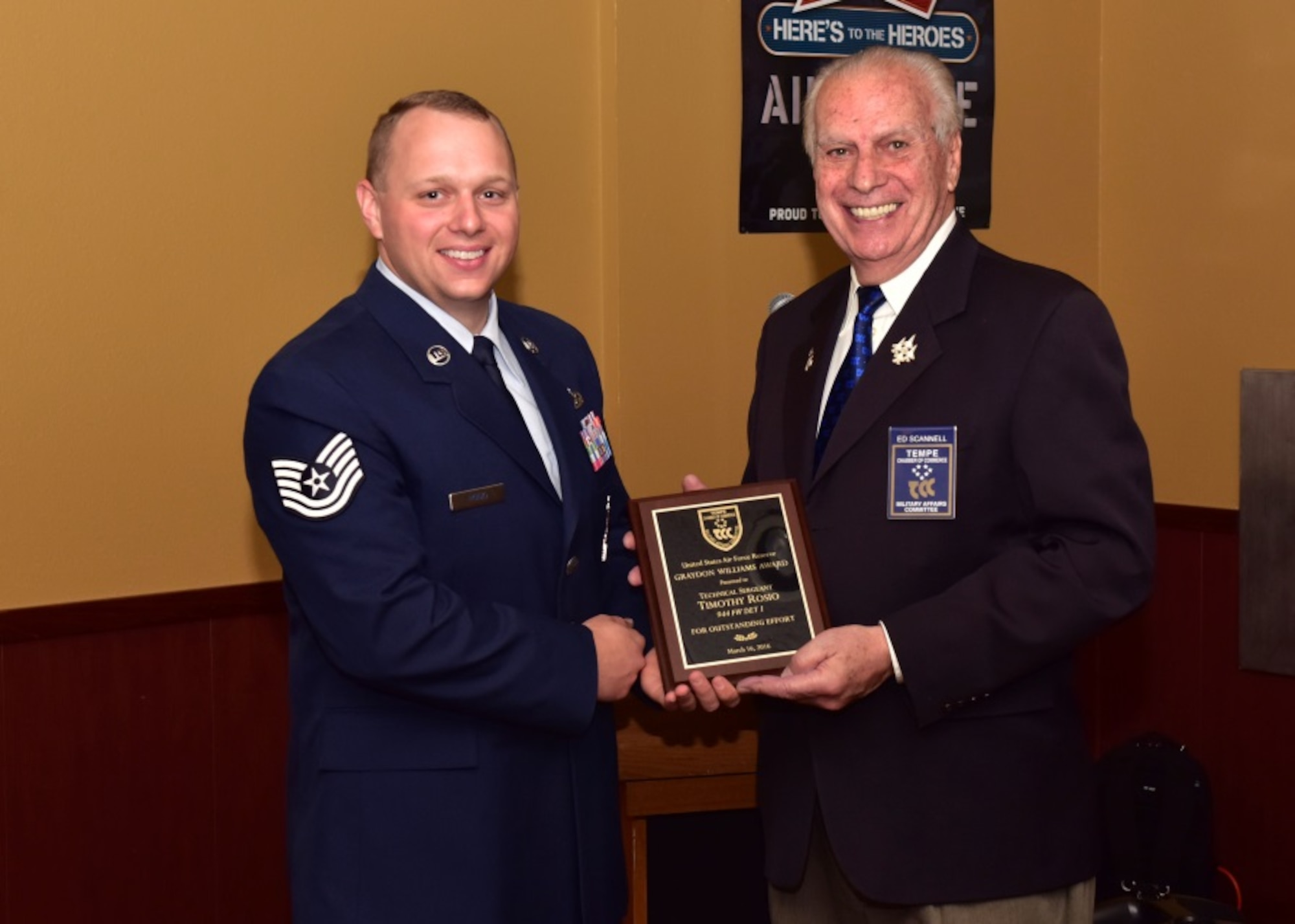 Tech. Sgt. Timothy Rosio, 944th Fighter Wing Detachment 1 Maintenance Unit,  weapons load crew chief, receives a plaque from Mr. Edward Scannell, Tempe Military Affairs Committee, as the winner of the Graydon Williams Award Mar. 16 during a ceremony held at Club Five-Six, Luke Air Force Base, Ariz. (U.S. Air Force photo by Tech. Sgt. Louis Vega Jr.)
