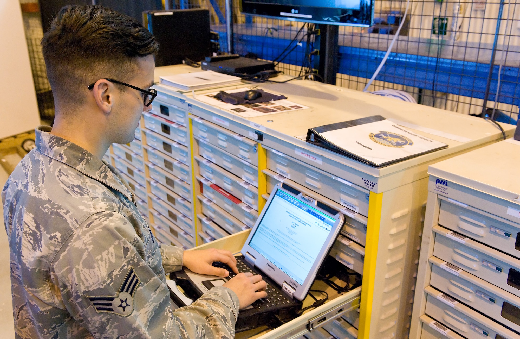 Senior Airman Bryon Grimco, 736th Aircraft Maintenance Squadron C-17A Globemaster III crew chief, checks for technical data using the C-17 Interactive Electronic Manuals installed on a Toughbook laptop March 21, 2016, on Dover Air Force Base, Del. Located in the 736th AMXS support section, a combination of laptop and tablet e-tools totaling 60, are maintained, stored and updated in lock and dock cabinets when not in use by C-17A maintenance personnel. (U.S. Air Force photo/Roland Balik)