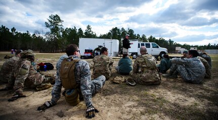 Airmen from the 1st and 3rd Combat Camera Squadron listen to a field medic instructor as he informs them on various medical procedures used while in the field on Fort Jackson, S.C., March 5, 2016. Exercise Scorpion Lens is an annual Ability To Survive and Operate training evolution mandated by Air Force 3N0XX Job Qualification Standards (3N0XX AFJQS). Individuals are instructed using a “crawl, walk, run” format of training. The exercise is twofold containing the Scorpion Lens portion, dedicated to Advanced Weapons and Tactical Training (AWTT) and the Flash Bang portion dedicated to providing photography and videography documentation standards in combat situations. The purpose of the training is to provide refresher training to combat camera personnel of all ranks and skill levels in basic tactics, techniques, and procedures inherent to combat camera mission tasking. (U.S. Air Force photo by Senior Airman Clayton Cupit)
