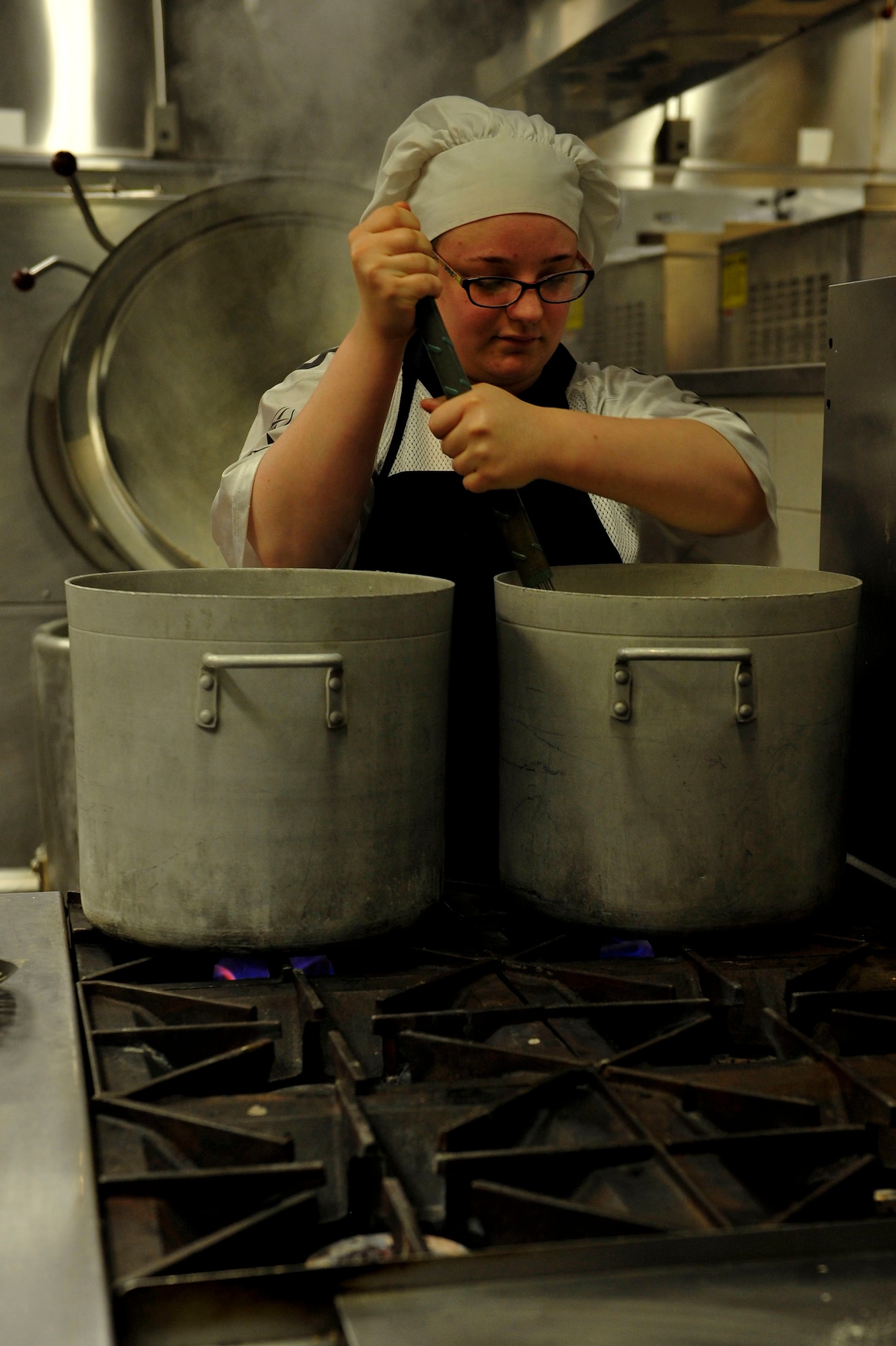 Katie Frinzi, Resolute Dining Facility culinary specialist, stirs soup for the lunch meals at Fort Eustis, Va., March 18, 2016. The culinary specialists begin preparing and cooking meals for lunch as soon as the breakfast crowd leaves. (U.S. Air Force photo by Airman 1st Class Breonna Veal)