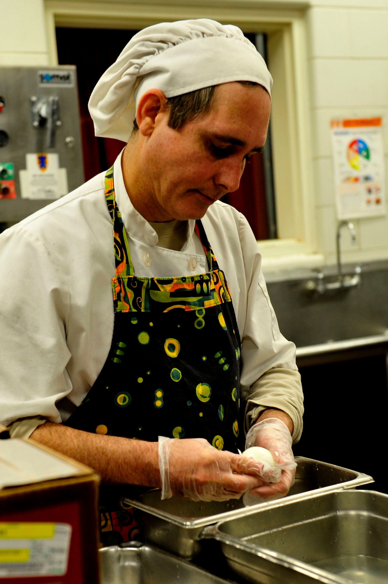 Wayne Jacobs, Resolute Dining Facility culinary specialist, peels eggs for a salad bar at Fort Eustis, Va., March 18, 2016. Advanced Individual Training students are offered two starches, two vegetables, and two meats during lunch and dinner to comply with U.S. Army regulations and ensure proper nutrition is provided for the students. (U.S. Air Force photo by Airman 1st Class Breonna Veal) 