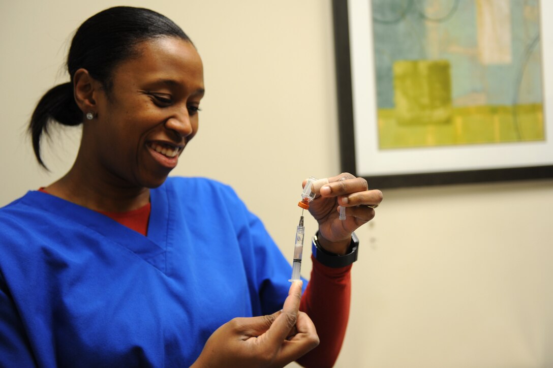 Dr. Nina Griffin, a veterinarian assigned to the Public Health Command-Fort Eustis Branch, prepares a vaccination for a patient at Langley Air Force Base, Va., Feb. 18, 2016. The Langley Veterinary Clinic offers a wide verity of vaccinations to include bordetella, rabies and Influenza. (U.S. Air Force photo by Senior Airman Brittany E. N. Murphy)
