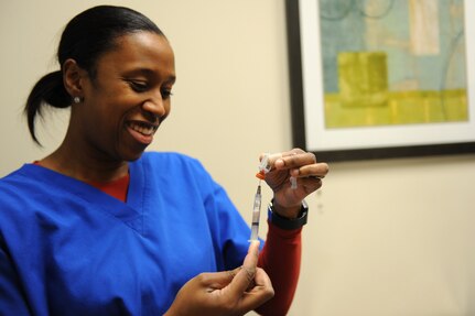 Dr. Nina Griffin, a veterinarian assigned to the Public Health Command-Fort Eustis Branch, prepares a vaccination for a patient at Langley Air Force Base, Va., Feb. 18, 2016. The Langley Veterinary Clinic offers a wide verity of vaccinations to include bordetella, rabies and Influenza. (U.S. Air Force photo by Senior Airman Brittany E. N. Murphy)
