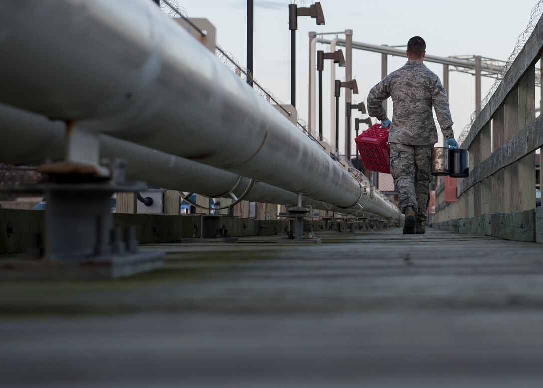 U.S. Air Force Senior Airman Jeremiah Garfoyle, a fuels laboratory technician assigned to the 733rd Logistics Readiness Squadron, carries fuel testing supplies at Langley Air Force Base, Va., March 18, 2016. Mid Atlantic Petroleum Services Inc. provides Langley with Jet A1 fuel for the T-38 Talon’s and F-22 Raptors. (U.S. Air Force photo by Airman 1st Class Derek Seifert)