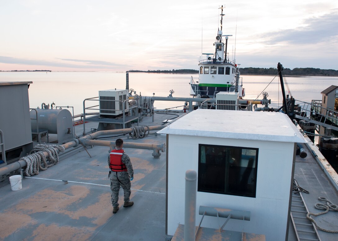 U.S. Air Force Senior Airman Jeremiah Garfoyle, a fuels laboratory technician assigned to the 733rd Logistics Readiness Squadron, walks a fuel barge at Langley Air Force Base, Va., March 18, 2016. In addition to testing all aircraft fuels, fuels technicians re-fuel all the aircraft on the installation. (U.S. Air Force photo by Airman 1st Class Derek Seifert)   