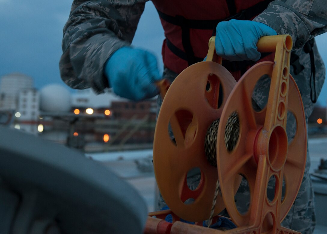 U.S. Air Force Senior Airman Jeremiah Garfoyle, a fuels laboratory technician assigned to the 733rd Logistics Readiness Squadron, collects fuel from an incoming shipment at Langley Air Force Base, Va., March 18, 2016. Garfoyle collects and tests fuel to ensure it stays within regulations to be safely used by F-22 Raptors. (U.S. Air Force photo by Airman 1st Class Derek Seifert)