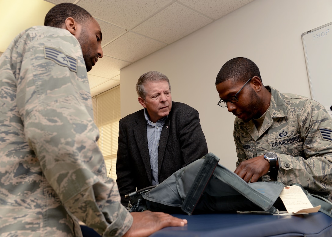 U.S. Air Force Staff Sgts. Alonzo Hickman and Lloyd Williamson, aircrew flight equipment technicians (AFE) assigned to the 1st Operations Support Squadron, show retired Chief Master Sgt. of the Air Force Rodney J. McKinley the improvements made to parachute equipment at Langley Air Force Base, Va., March 18, 2016. Since his time as the 15th CMSAF, flight equipment, such as parachutes, helmets and survival kits have undergone advances to increase pilot safety.  (U.S. Air Force photo by Airman 1st Class Kaylee Dubois)